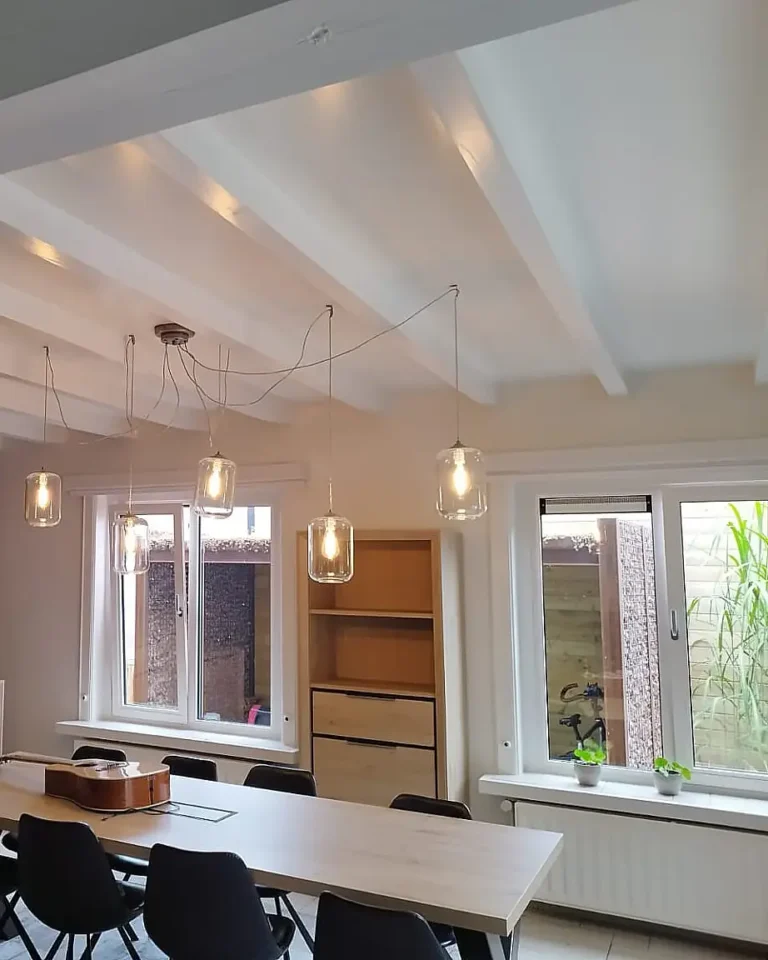 Professioneel schilderwerk in een woonkamer met strak afgewerkte wanden en houten afwerking